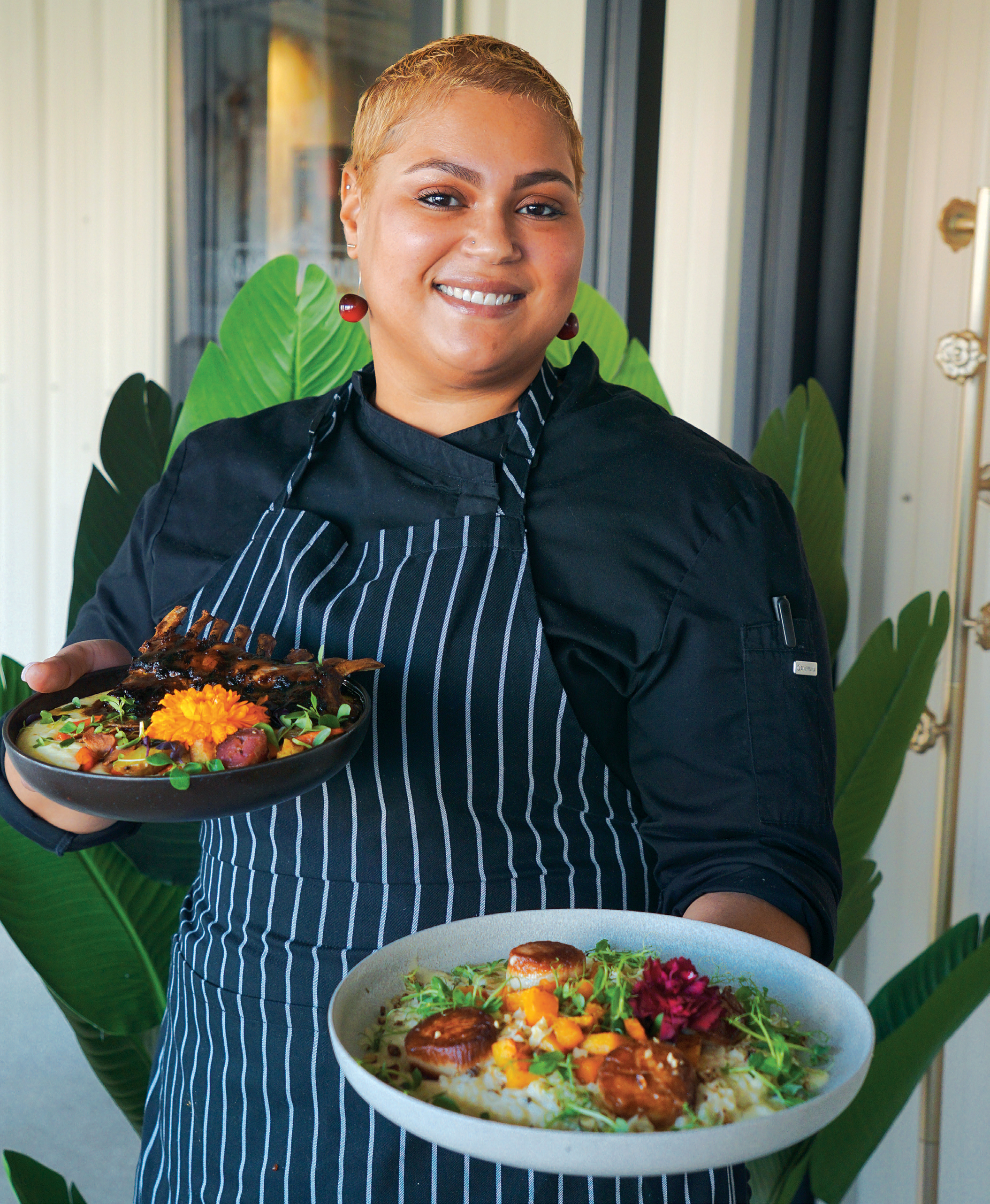 Chef Chamaigne Stone puts a colorful spin on classic dishes at Jackson House in Middletown. Here, she holds a rack of lamb and scallops with risotto and butternut squash. Women are the force behind the restaurant.