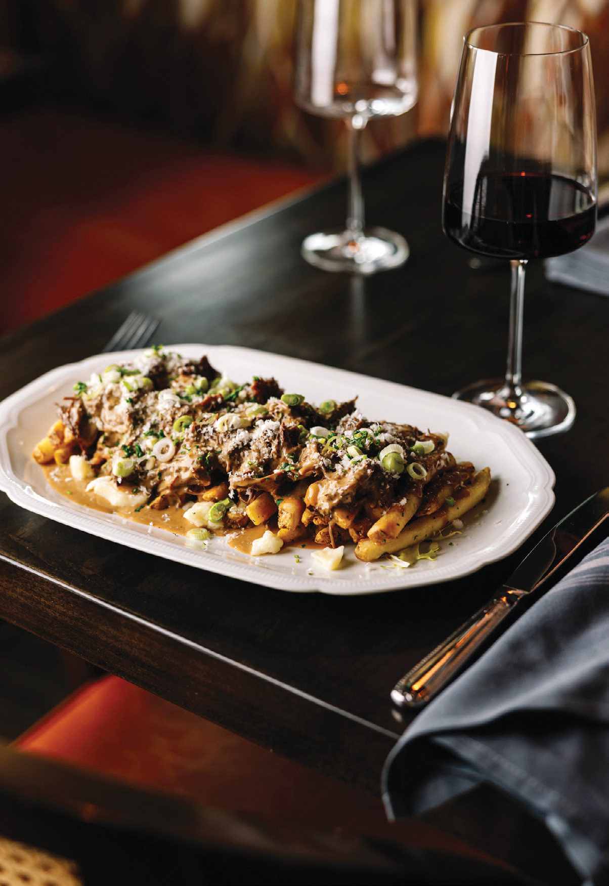 Brandy wine Brasserie offers several takes on french fries, including poutine. The Canadian favorite consists of fries tossed with cheese curds and gravy. The restaurant adds braised short rib and a brandy gravy.
