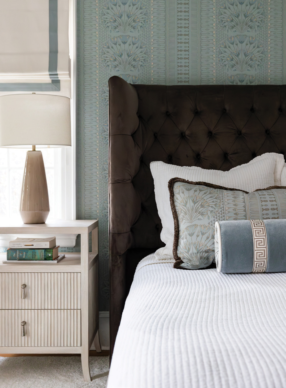 The primary bedroom is inviting with soothing wallpaper from Thibaut. The new family room is light and cozy thanks to plenty of windows and plush fabrics.In the mudroom there is lots of storage including a custom dresser.